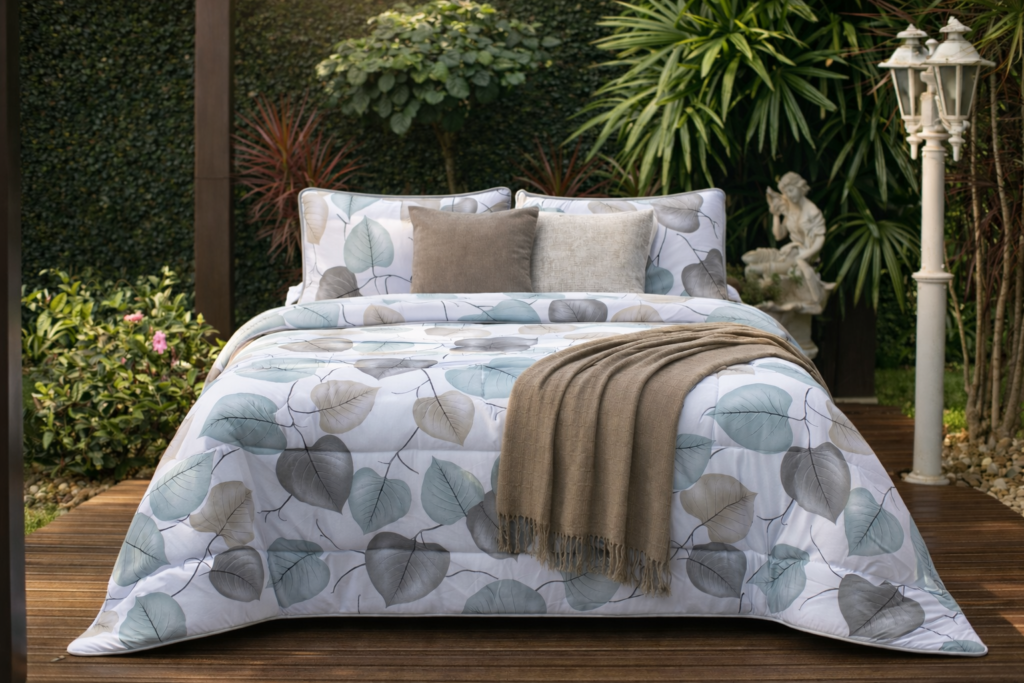 Cama posta com manta decorativa dobrada no pé da cama e almofadas Cama posta com manta decorativa dobrada no pé da cama e almofadas